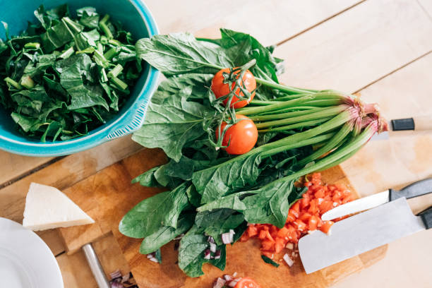 High angle view of fresh vegetables. Food is on cutting board. It is in kitchen at home.