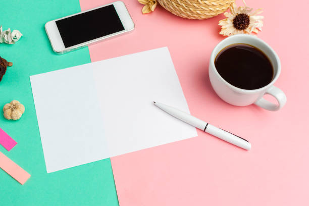 istock Blank paper with smart phone on desk.top view,flat lay 1271671741
