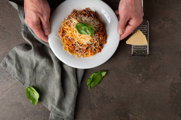 istock Overhead view of pasta in hands on stone table 1271673017