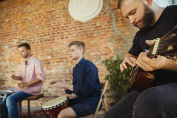 istock Musician band jamming together in art workplace with instruments 1271673156