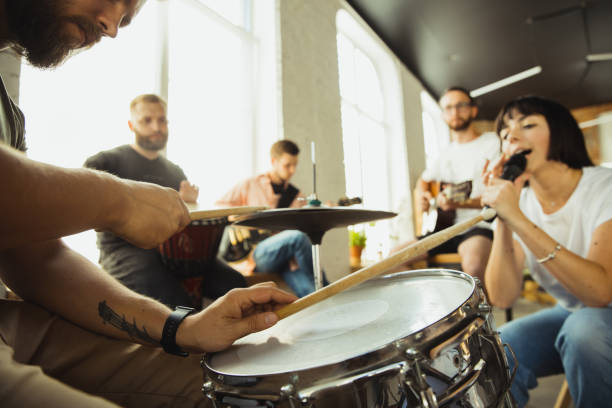 istock Musician band jamming together in art workplace with instruments 1271673219