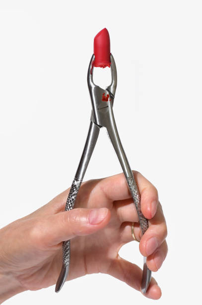 istock Conceptual Dental pliers tool and red lipstick 1271673962