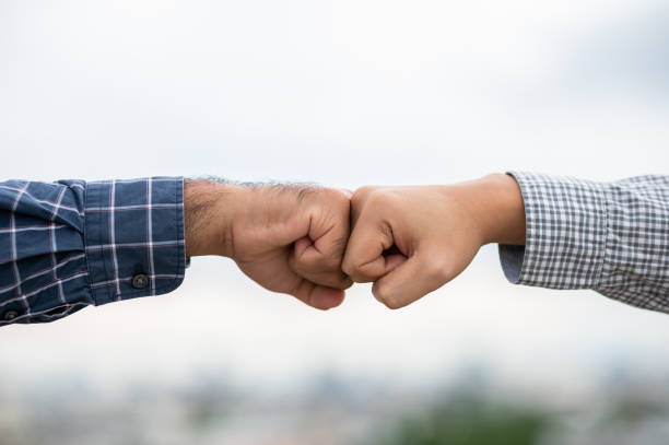 istock Two business man hands use fist bump for succes teamwork corporate 1271675285