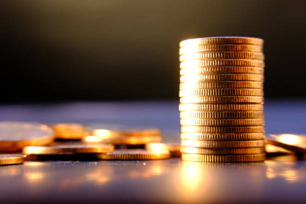 istock Close up of coins on black background 1271675667