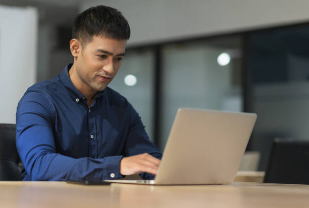 istock Young asian businessman working with laptop in office. 1271676462