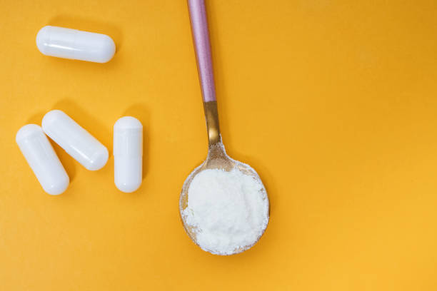istock Collagen powder and pills on yellow background 1271677479