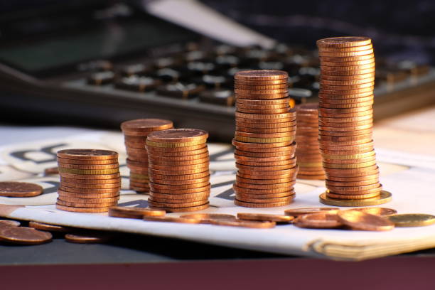 istock Stack of golden coins on black background 1271677661