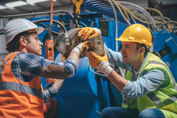 istock Industrial machinery male employees working with remote control for operating crane 1271677895