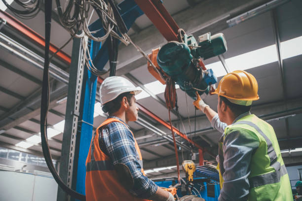 istock Industrial machinery male employees working with remote control for operating crane 1271678104
