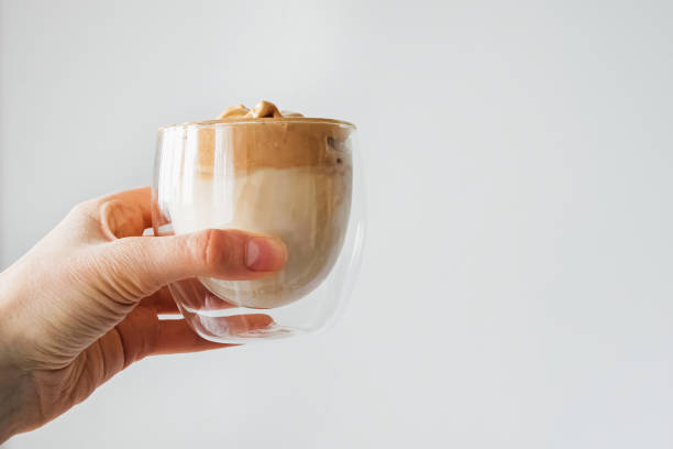 istock Hand holding a glass of Dalgona coffee latte 1271678516