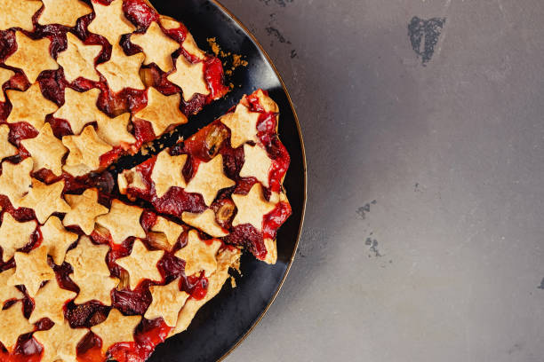 istock Strawberry and rhubarb pie decorated with stars on white table, top view 1271678538