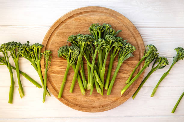 istock Fresh raw broccolini or baby broccoli on wooden board 1271678608