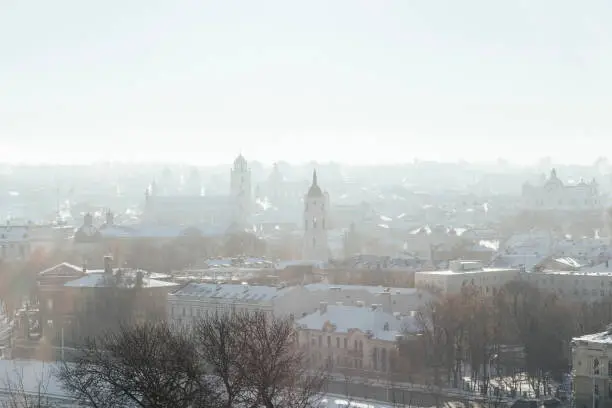 January 7, 2017 - Vilnius, Lithuania:Amazing Vilnius panorama from above with snow and winter mist, fog over the Old Town with churches, bell towers and river visible in white clouds.