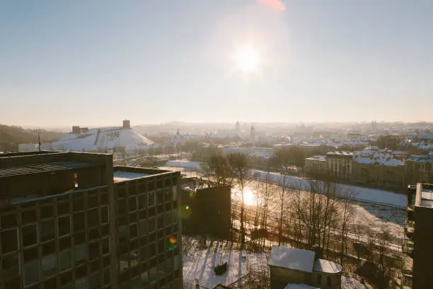 January 7, 2017 - Vilnius, Lithuania: amazing winter view over Vilnius old town - white mist and snow covering urban places and river, glistening in morning sun and shining.