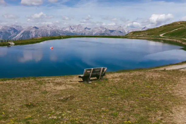 July 20, 2020 - Austria: Awesome nature in Austrian Alps - turquoise lake with bench, tranquility, getting away from it all - summer mountains landscape.