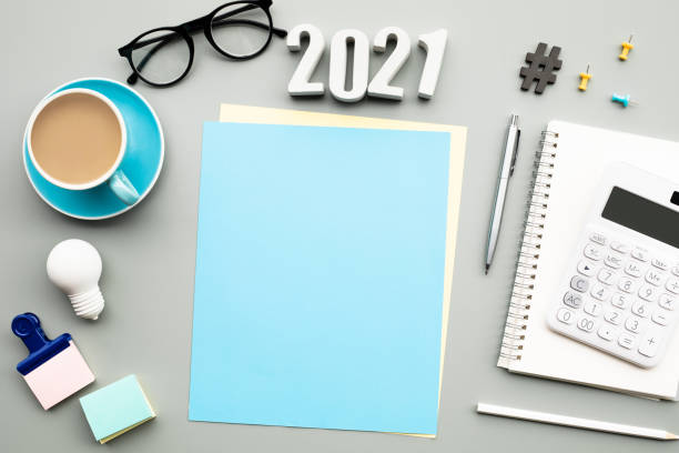 istock 2021 text with modern accessories of worker on table background 1271681705