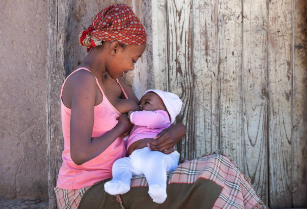 African mother breastfeeding Single young African mother in a village in Botswana, the drama of single mothers from the third world botswana photos stock pictures, royalty-free photos & images