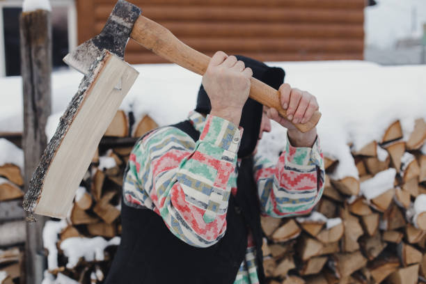 istock Man cutting firewood for the winter in the yard 1271683749