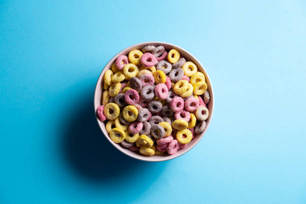 istock Isolated bowl of mixed cereals and marshmallows on blue background 1271684328