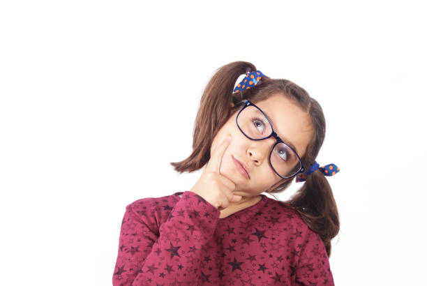 istock Thoughtful little girl looking up thinking isolated on white background 1271685095