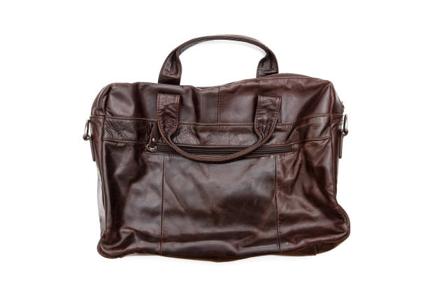 istock Used vintage leather bag, suitcase briefcase isolated on white 1271686042
