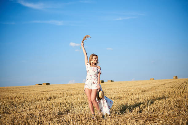 istock Beautiful woman walking in the field 1271686049
