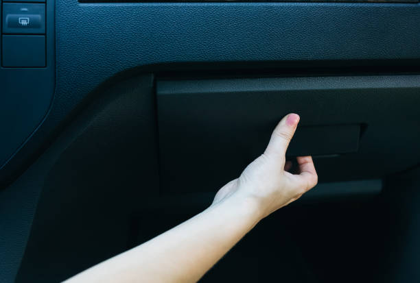 Woman is opening glove compartment in the car. Woman is opening glove compartment in the car. glove box stock pictures, royalty-free photos & images