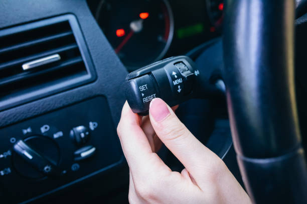 istock Woman is pressing buttons in the car while driving. 1271686320