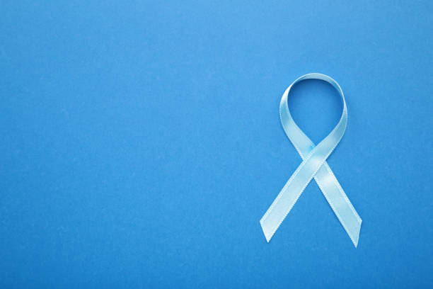 istock Blue breast cancer ribbon on blue background. 1271687109