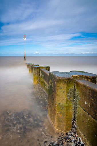 Long exposure photograph of wooden sea defences at high tide. Exposure time in excess of 60 secs