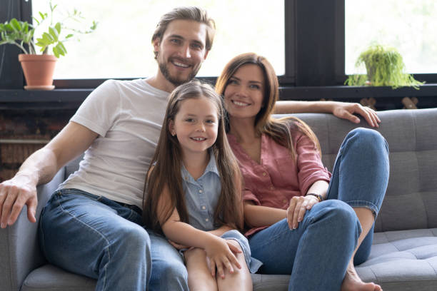 istock Cheerful family at home sitting in sofa. 1271688987