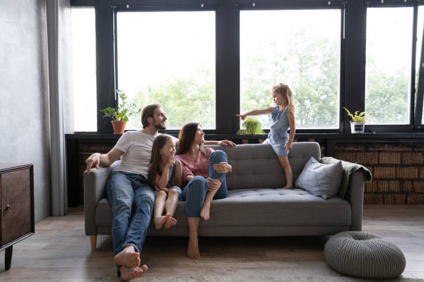 istock Cheerful family at home sitting in sofa. 1271688989