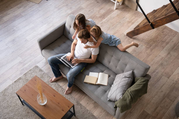 istock Caucasian male working from home with children, checking documents. 1271689503