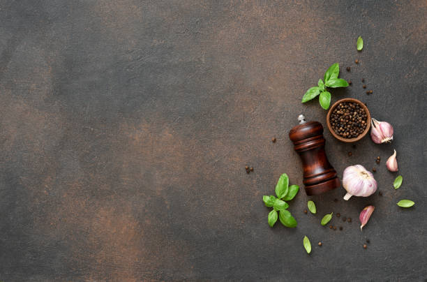 istock Salt, peppercorns, fresh basil on a concrete background. View from above. 1271689859