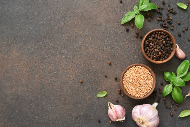 istock Salt, peppercorns, fresh basil on a concrete background. View from above. 1271689871