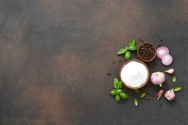 istock Salt, peppercorns, fresh basil on a concrete background. View from above. 1271689903