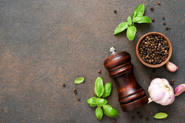 istock Salt, peppercorns, fresh basil on a concrete background. View from above. 1271689920