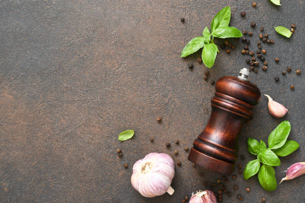 istock Salt, peppercorns, fresh basil on a concrete background. View from above. 1271689925