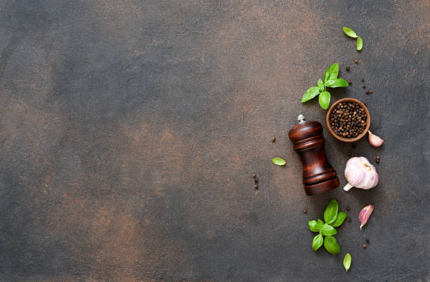 istock Salt, peppercorns, fresh basil on a concrete background. View from above. 1271689957
