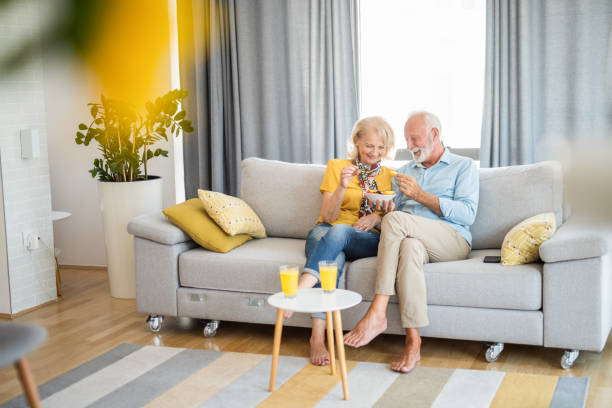 istock Senior couple eating a fruit salad together. 1271690630
