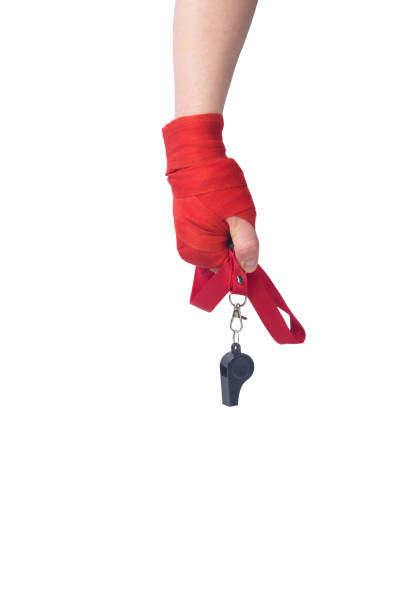 black whistle on a red ribbon, for giving the command, in the hand, on a white background, there is a place for the inscription