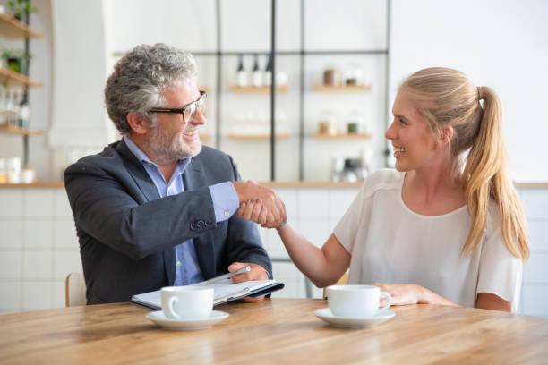 istock Mature expert meeting with young customer 1271691139
