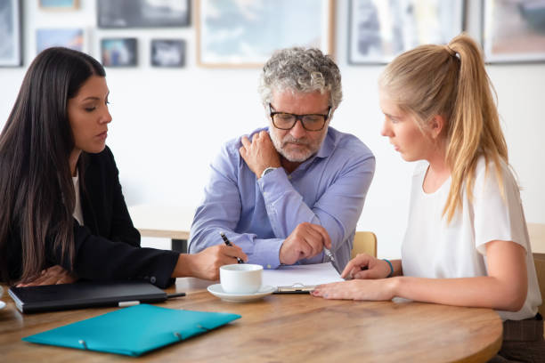 family legal advisor explaining document details - lawyer family talking discussion imagens e fotografias de stock