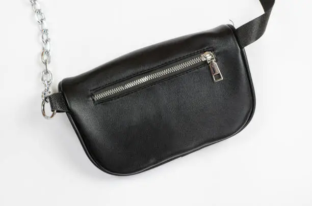 Photo of Black leather waist bag isolated on white background.