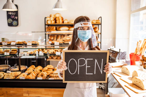 istock Woman working at a bakery wearing a facemask to avoid the coronavirus. 1271693046