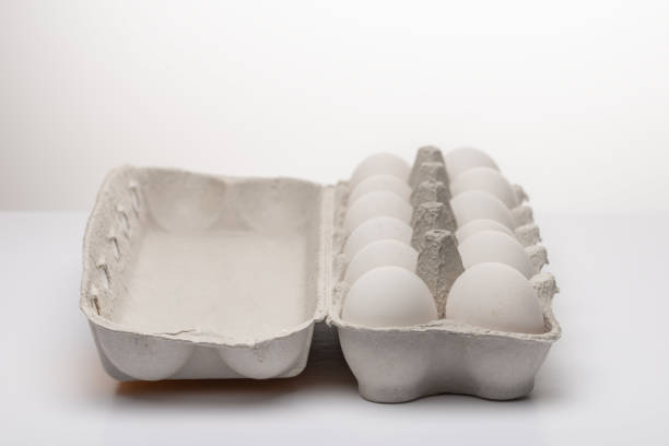 istock White eggs in carton box isolated on white background. 1271693093