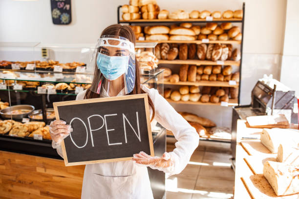 istock Woman working at a bakery wearing a facemask to avoid the coronavirus 1271693162