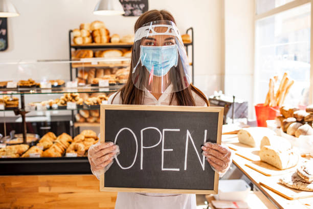 istock Woman working at a bakery wearing a facemask to avoid the coronavirus. 1271693213