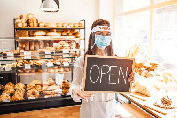 istock Owner of bakery shop smiling behing her mask. 1271693315