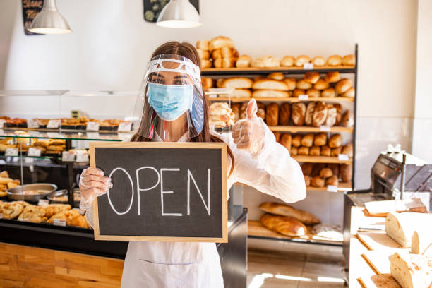 istock Woman working at a bakery wearing a facemask to avoid the coronavirus 1271693345